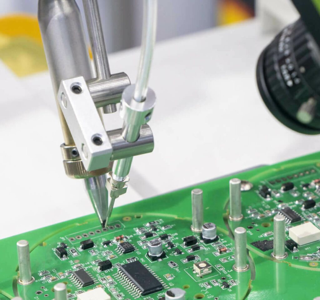 The robotic system for the soldering process with the electronics board in PCB assembly. The electronics circuit board manufacturing process by soldering robotic system.