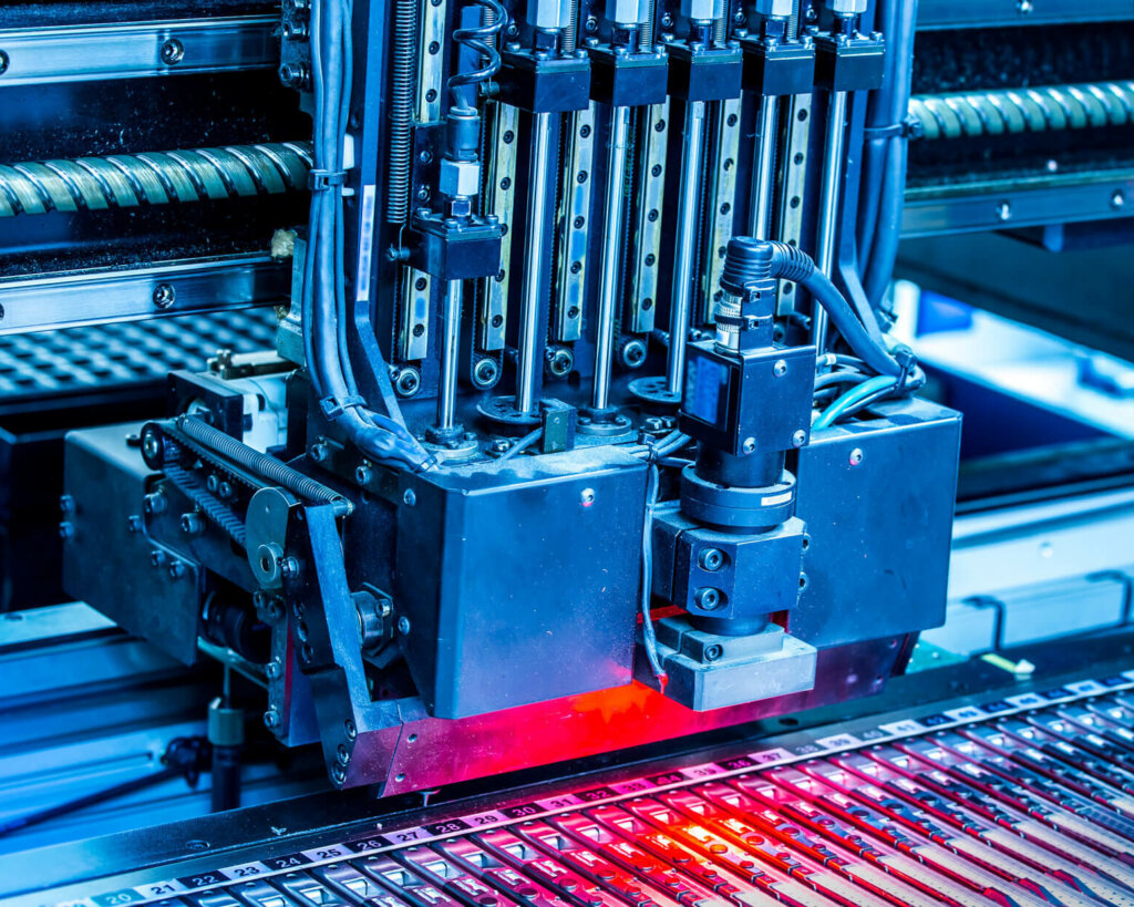 Close-up surface-mounting machine in progress in PCB assembly. SMT (surface-mount technology) is a method for producing electronic circuits. Components are placed directly onto the surface of printed circuit boards.